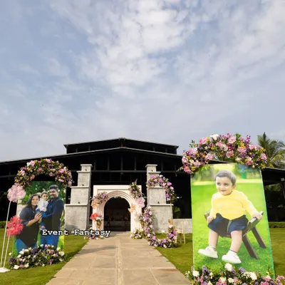 Creating a personal journey for guests as they arrive. For Dhanvith's naming ceremony, I lined the entrance path with large, beautiful portraits of the baby, each adorned with fresh flowers.