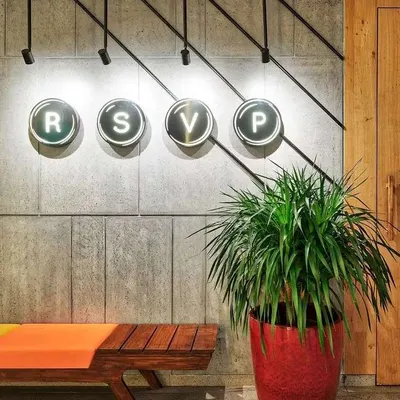 A single, large plant can make a bold statement. This lush indoor palm in a vibrant red FRP planter adds a pop of color and natural texture to a modern commercial space, instantly making it feel more inviting.