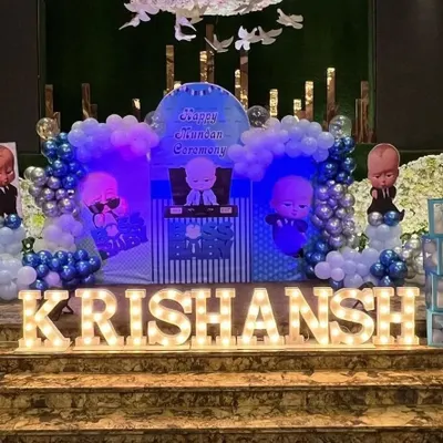 I also provide decorations for Mundan ceremonies, like this "Boss Baby" themed setup. The stage includes character backdrops, blue and silver balloon columns, and large marquee letters for the child's name.
