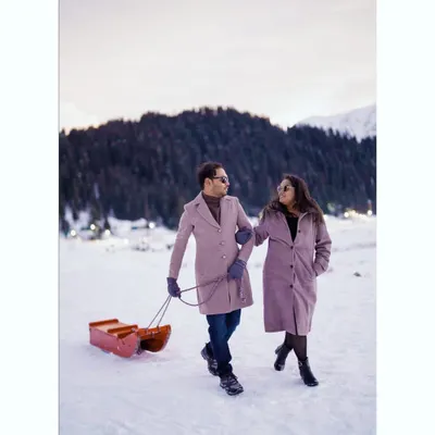 A romantic stroll through the snow in Kashmir. This pre-wedding shoot captures a quiet, cozy moment against a majestic winter landscape, showcasing the couple's connection.