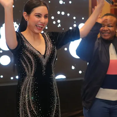 My goal is to spread happiness and get everyone involved. This candid shot captures the energy I bring to the stage, ensuring your celebration is lively and full of memorable moments.