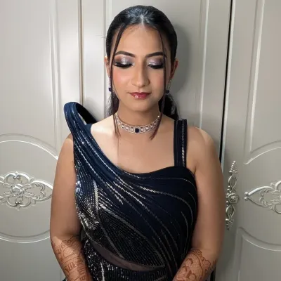 A modern and chic cocktail look featuring sharp, silver-toned smokey eyes and a sleek ponytail. This makeup is designed to be dramatic yet sophisticated, perfect for an evening of celebration.