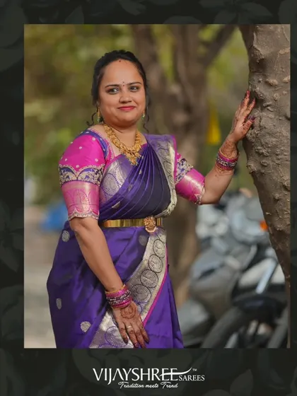 Soujanya Bharath looks regal in a deep purple Kanjivaram with a silver zari border and a contrasting pink embroidered blouse.