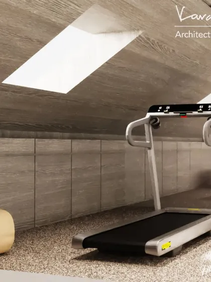 An attic gym space, showing how we can transform unconventional areas into highly functional rooms. The sloped ceiling and skylights create a unique atmosphere for a workout.