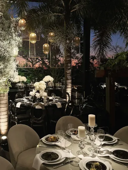 As dusk settles, the hanging glass pendants and candles create a magical, intimate atmosphere. The decor is designed to be just as beautiful after the sun goes down.