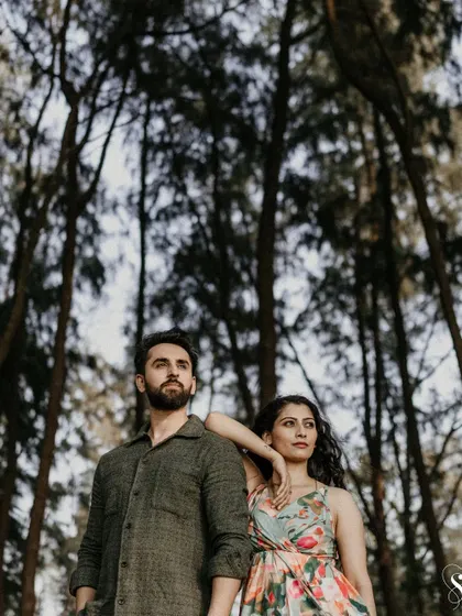 A striking pose among the tall trees. This shot uses the vertical lines of the forest to create a powerful and artistic portrait that feels both grand and intimate.
