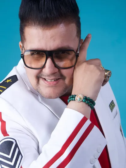 Dressed for the occasion in a custom white jacket. My look is part of the performance, projecting confidence and a larger-than-life persona that matches the energy of my music.