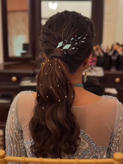 This textured ponytail is perfect for a sangeet or cocktail event. It's stylish, secure, and keeps the hair off the face for a night of dancing.