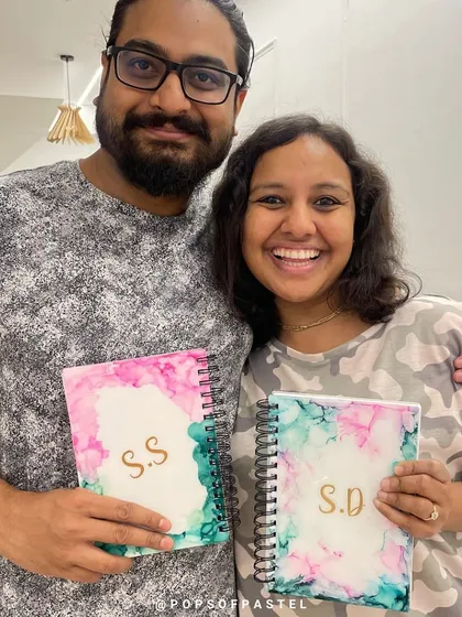 So much joy in their creation! This couple is thrilled with the personalized diaries they made together during their special anniversary art session.