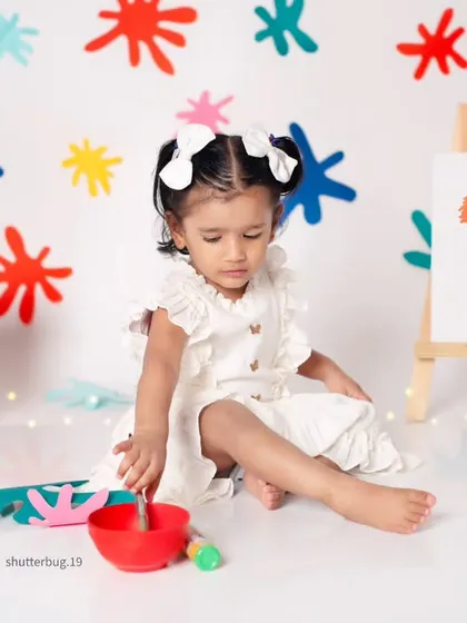 A little artist at work during her second birthday paint-splash photoshoot.