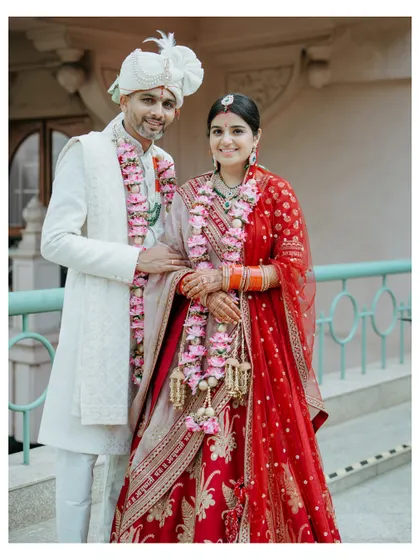 A classic portrait of the newly married couple after their ceremony at Leela Palace Bangalore, their smiles radiating love and happiness.