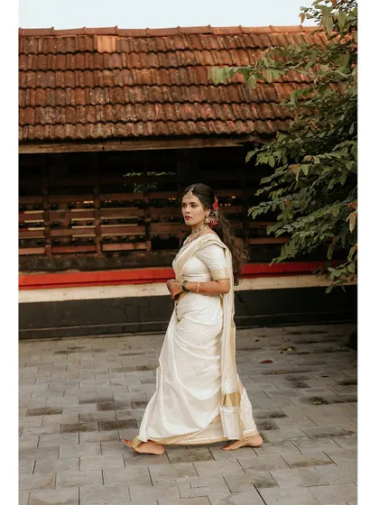 A graceful full-length portrait of the bride walking in a traditional courtyard.