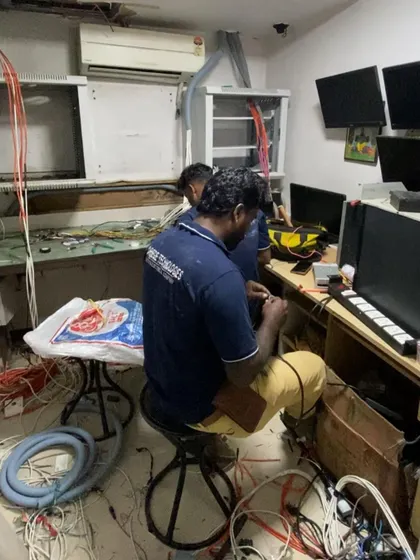 This image shows my team at work in a control room, managing the complex wiring required for an integrated security and IT network. I ensure every connection is secure and organized for reliable performance.