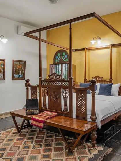 A look inside our luxurious Arundati suite, featuring a classic four-poster bed and antique furnishings. We offer heritage accommodation to ensure your comfort matches the elegance of your celebration.