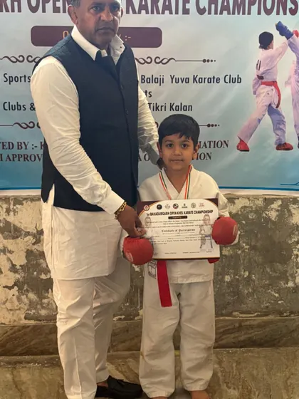 One of my youngest students receiving his certificate and medal. Discipline starts early.