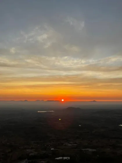 A stunning, wide view of the sunrise, with the orange and yellow sky stretching across the horizon.