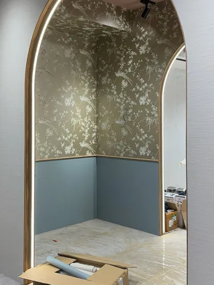 The beginning of Zone Two, where the mood shifts to something more delicate and romantic. This image shows the space after the wallpaper and paint were applied, with the clean, lit archway ready for the layers of bespoke furniture and decor.