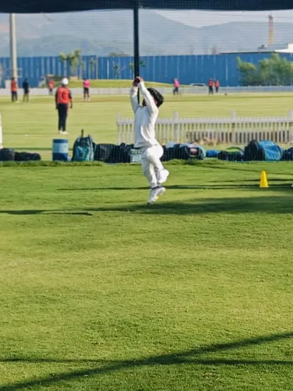 Full stretch for the catch. This image captures the commitment of our young players as one leaps to intercept a high ball, showing the athletic dedication we foster.