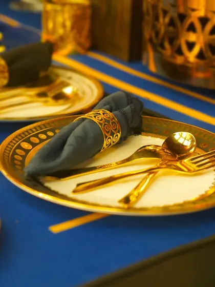 A bold and beautiful table setting featuring royal blue and gold. We work to ensure our presentation complements the event's decor and theme perfectly.