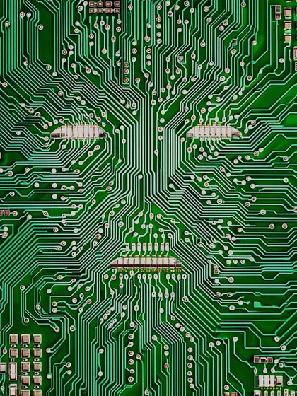 A face emerges from the intricate pathways of a green circuit board. A simple, early exploration of the 'ghost in the machine' concept.