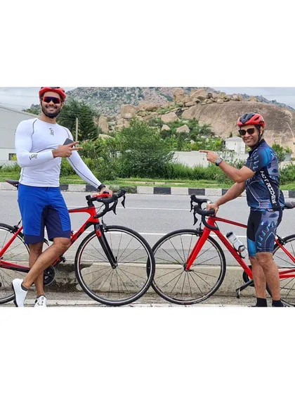 Posing with our bikes against the scenic backdrop of Nandi Hills. I coach clients on the best cycling routes around Bengaluru.