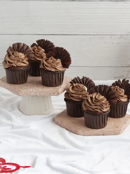 For the chocolate lover in your life, our rich chocolate cupcakes with chocolate frosting and fan decorations are a decadent Valentine's Day treat.