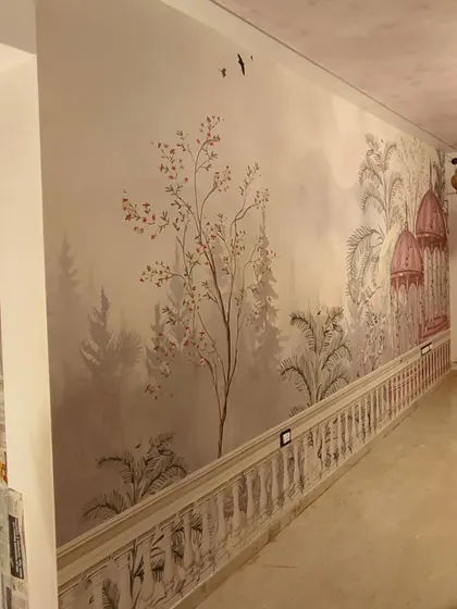 A long hallway featuring a premium canvas wallpaper with a serene Indian landscape of gazebos and trees. The length of this wall required perfect alignment to maintain the continuous scene.
