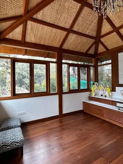 The finished interior of a sacred temple space we designed. The vaulted ceiling is lined with woven natural material, complementing the rich hardwood floors and creating a serene, organic atmosphere for worship.
