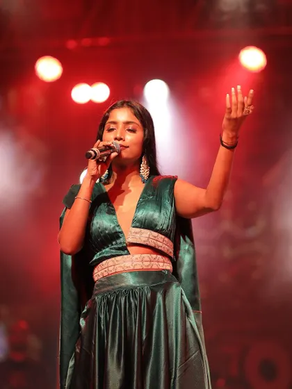 A close-up shot showing the confidence and energy of the performer. The outfit complements her stage presence perfectly.