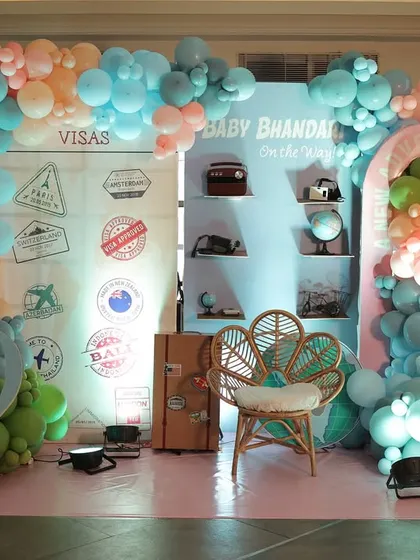 The full, vibrant setup for the 'Baby Bhandari' travel-themed shower, featuring passport and visa details.