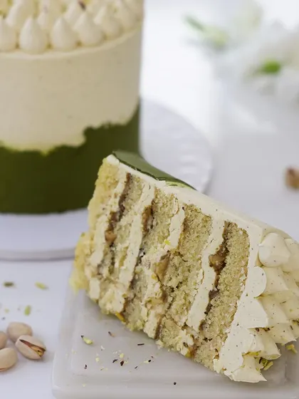 We craft a uniquely sophisticated flavor profile with our pistachio custard cake. The subtle green hue and piped cream topping create an elegant and understated design, perfect for celebrating Mother's Day with a gourmet touch.