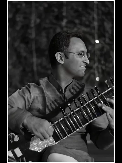A black and white shot from an evening performance, with beautiful bokeh lights in the background.