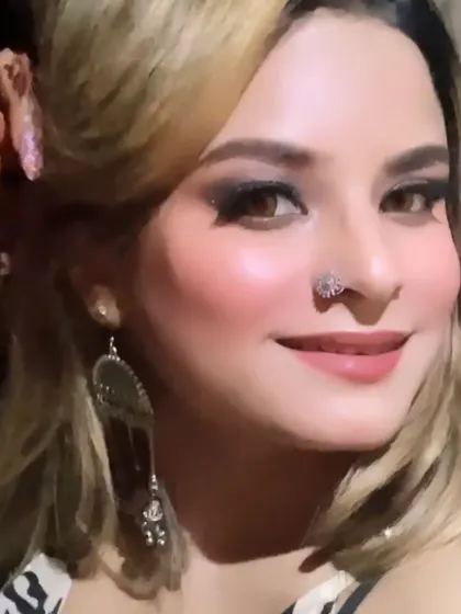 A full-face view of the cocktail look, complete with a stylish nose pin and statement earrings.