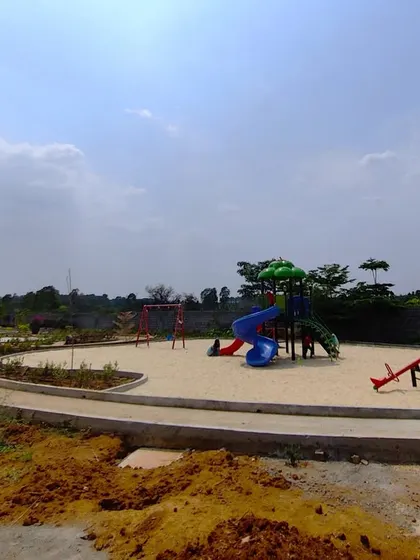 A wider view of the play area at 'The Sanctuary' under construction, showing the arrangement of different play equipment.