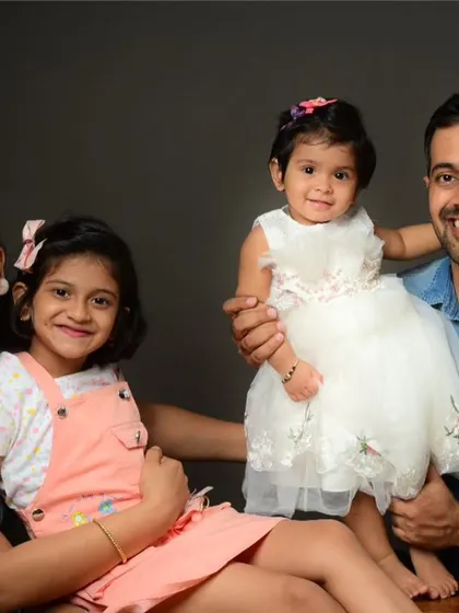 A bright and cheerful family portrait. The genuine smiles are a result of a relaxed and fun photoshoot experience.
