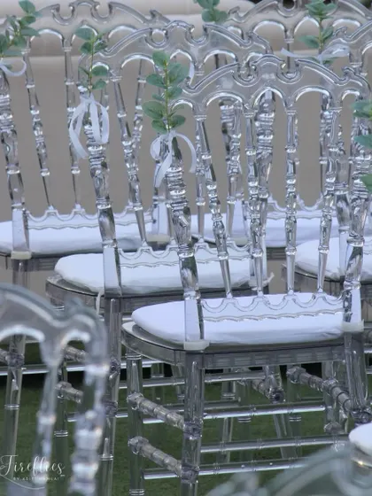Elegant transparent 'ghost' chairs were used for guest seating, adding to the light and ethereal feel of the all-white theme.