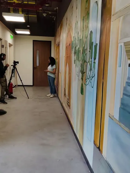 Here I am being interviewed in front of the Microsoft mural, explaining the thought process behind the concept and how we brought the history of Hyderabad's palaces to life on this 33-foot wall.