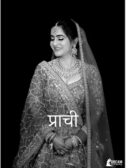 A beautiful black and white portrait of bride Prachi, her smile and traditional attire captured timelessly.