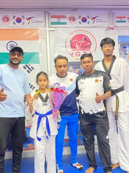 Celebrating Naysha's CBSE Central Zone gold medal win at our academy with fellow coaches.