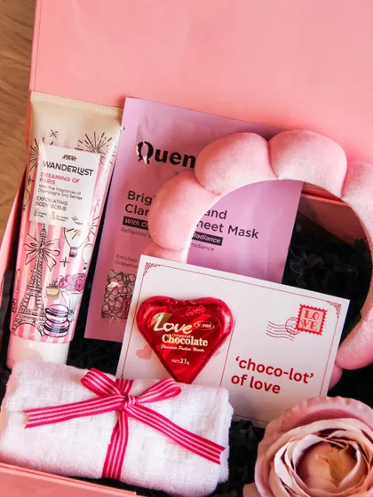 The 'Love & Glow' spa-themed hamper is perfect for a Galentine's gift or for pampering your partner. It includes face masks, scrubs, a spa headband, and chocolate.