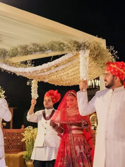 The bride's entry under a beautiful phoolon ki chadar.