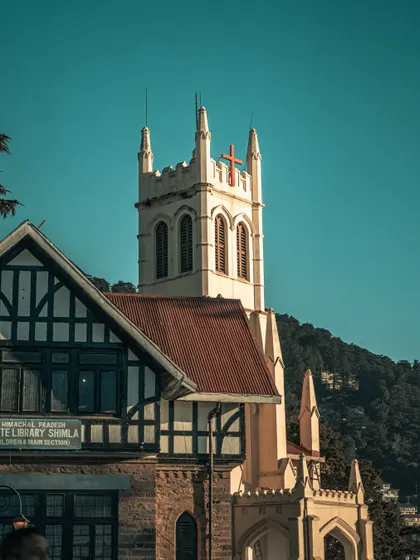 Christ Church and the State Library in Shimla, two beautiful examples of the city's colonial architecture, set against a clear blue sky.