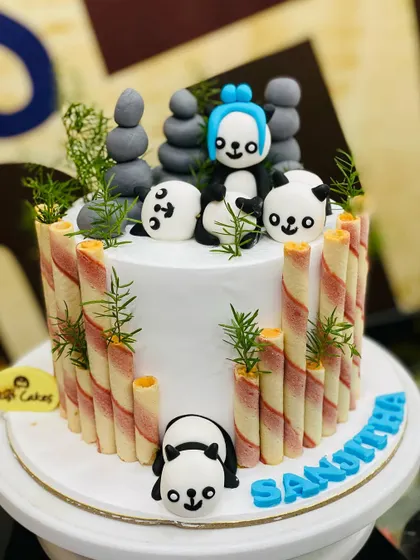 An adorable 2kg panda cake decorated with wafer-stick "bamboo" and playful fondant pandas.