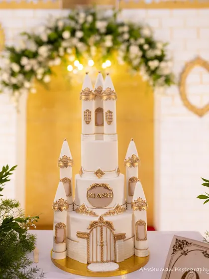 The centerpiece of a fairytale party. This magnificent castle cake, detailed with gold accents, was custom-designed to perfectly match the royal theme of a first birthday celebration.