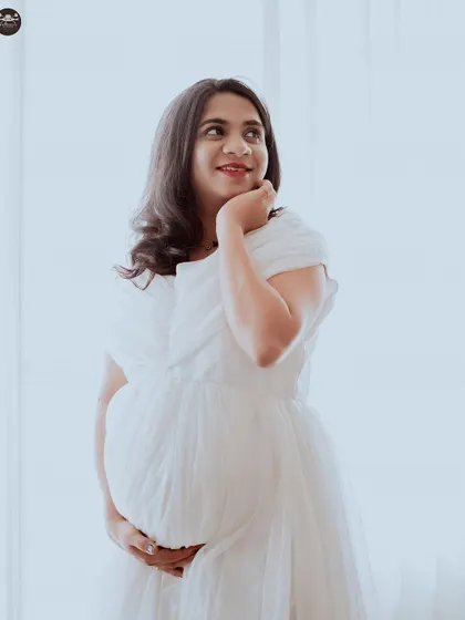 A classic pose against a clean white backdrop. This minimalist approach results in timeless maternity photos that are all about capturing the quiet joy and anticipation of this special time.