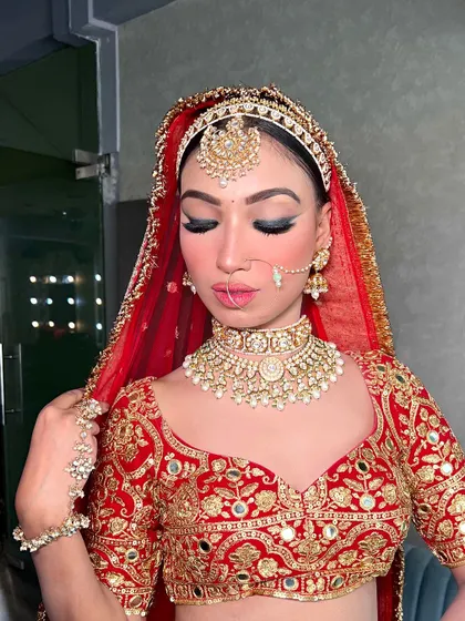 A close-up showcasing the bold eye makeup and the stunning kundan choker paired with our red and gold embroidered blouse.