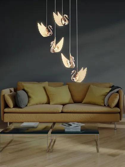 The swan chandelier shown in a living room, adding a touch of whimsical elegance.