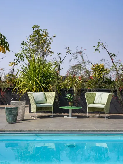 The poolside lounge area on the Kanasu rooftop, a perfect space for relaxation and enjoying the Bangalore weather.