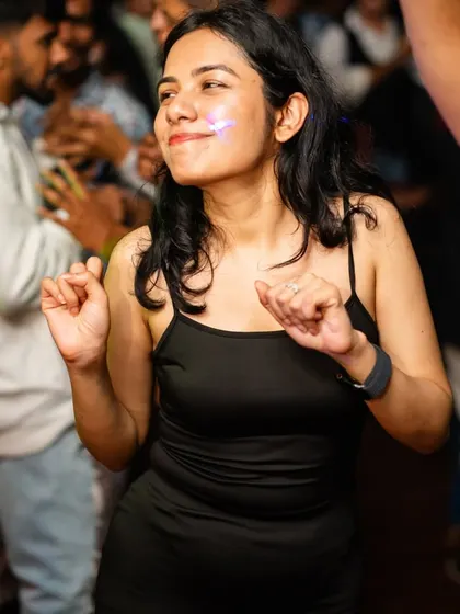 A partygoer lost in the music, feeling the beat. This is what a great DJ night is all about.