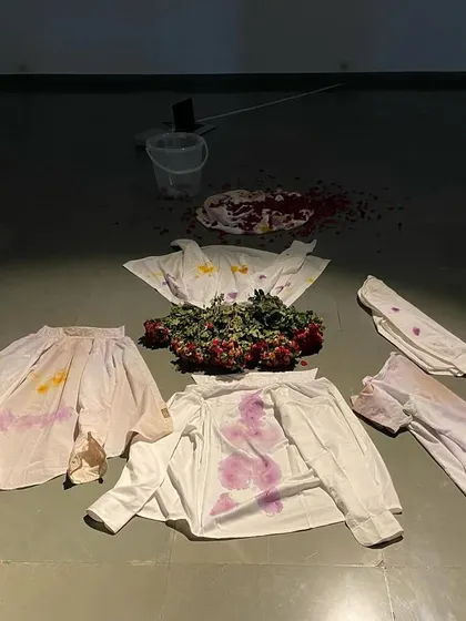 The culmination of the live performance, where flower-stained fabrics are arranged on the floor. The artwork is the process itself, and what remains is a trace of the actions performed.